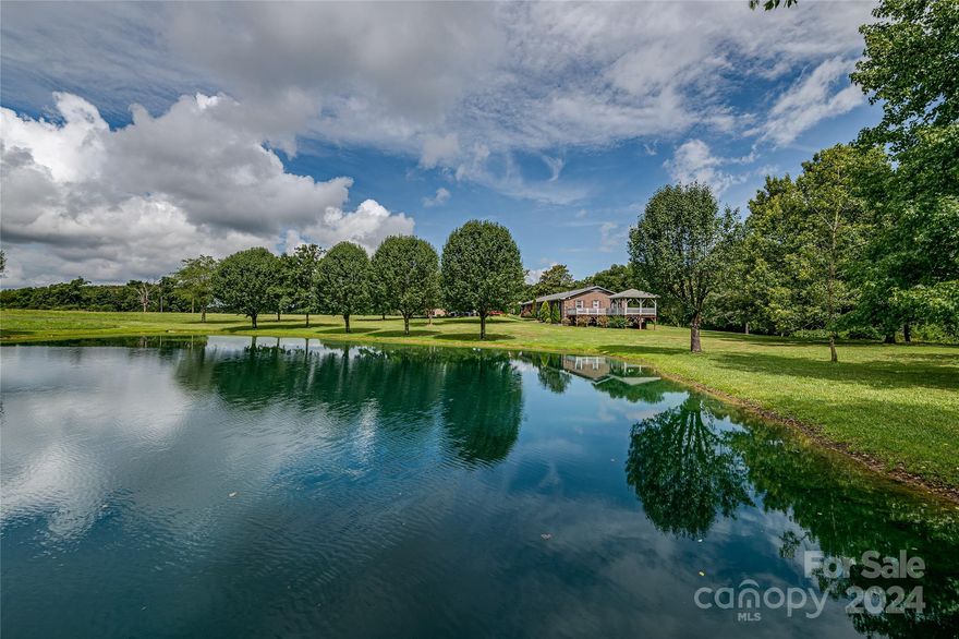 Discover this idyllic custom-built 3-bedroom, 2-bathroom home nestled on over 11 acres of picturesque land. Enjoy breathtaking views of a large, beautiful pond from the deck and gazebo just off the primary bedroom. Equipped with a 21 foot pier, the fully stocked pond teems with bass, bream, and catfish, offering delightful fishing opportunities.

The property also features a pond house with heating, air conditioning, and a bathroom, making it perfect for guests. An established vineyard with scuppernong and muscadine grapes adds to the charm, alongside an established pear tree and a newly planted fig tree. Start working on all the projects you want in the large workshop or use it to store two more cars. This unique property is a harmonious blend of comfort and nature, perfect for those seeking a tranquil lifestyle.