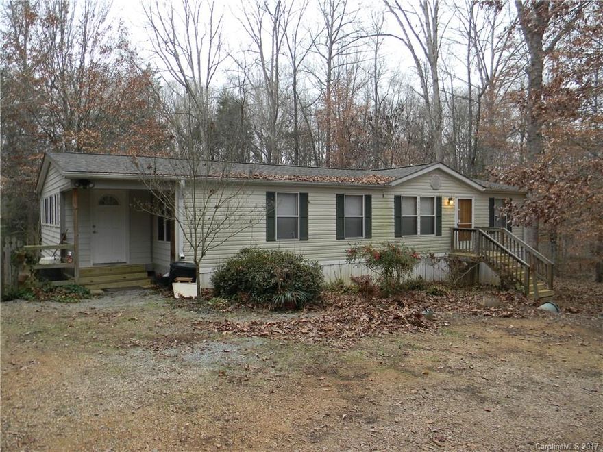 Nice double wide mobile home with sun room nestled on 2.81 acres.  Home needs a little work and then it will be the perfect home for your family.  Kitchen cabinet doors are in the house.  This parcel is zoned for two homes.