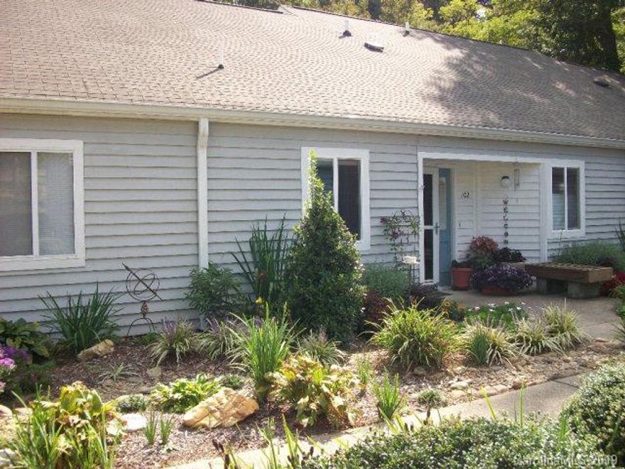 PRICE REDUCTION!! Completely Remodeled Condo located in a desirable area of beautiful Black Mountain. Enjoy the sound of the flowing creek that runs next to the screened-in back patio, while taking in the views of the seasons.No expense was spared for this lovely 2bd/2ba one level home. A complete Remodel includes some of following: All windows were replaced with new Pella windows, a new pallet of light colors tastefully flow from room to room; all wood interior doors installed, new sliding door, easy to maintain wood laminate flooring, new water heater, new light fixtures, Federal Pacific electric panel box was replaced, both bathrooms were updated with new vanities and Corian countertops, and a total kitchen makeover having new maple tone wood cabinets, new countertops, & appliances, & much more to see. Non smoking home. Wont last long