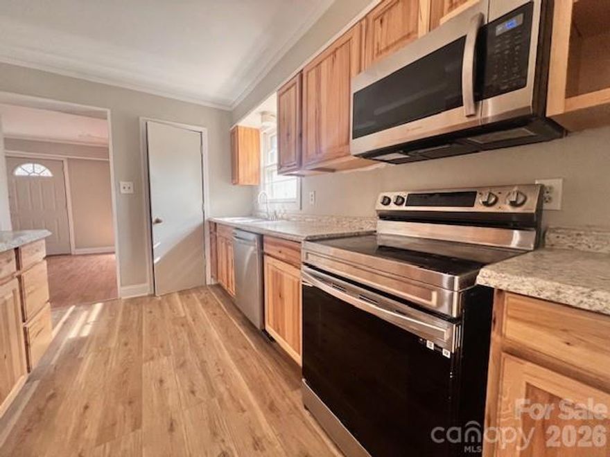 Well-done ranch offers you space inside and outside!  Enjoy mornings in the front living room/home office quietly sipping coffee while the sun streams through the windows.  Gatherings will be a blast with a sizable bonus room and family room hugging the updated kitchen.  Speaking of, this kitchen is fully outfitted with stainless steel refrigerator, stove, dishwasher and microwave as well as plenty of storage.  On rainy nights, the drops on the metal roof will sing you to sleep and on sunny days, enjoy chilling outside on your .71 acre lot.  All the peace and quiet you could want and located close to local eateries and parks.