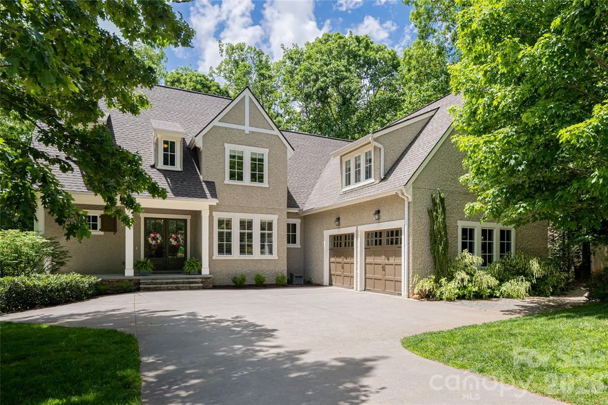 Welcome to your dream home! Nestled in the gated Southcliff community just outside the Asheville city limits, this stunning escape offers a peaceful mountain setting while remaining minutes from downtown Asheville and the Blue Ridge Parkway. Reflecting the charm of Biltmore Village Tudor Revival style, this beautifully renovated home captures mountain views and blends comfort with style.

Step inside to a spacious, light-filled floor plan featuring an open living area ideal for entertaining. The modern kitchen is appointed with quartz countertops, a gas cooktop, updated lighting, and ample cabinetry. The main-level primary suite includes a renovated bathroom with a soaking tub. Upstairs, multiple bedrooms and flexible space provide options for a home office or game room. The walk-out basement adds versatility with a home theater, gym, and second office.

Outside, a flagstone patio and beautifully landscaped backyard abutting Southcliff’s protected conservancy area await—offering a tranquil natural backdrop and easy access to the outdoor lifestyle this area is known for.