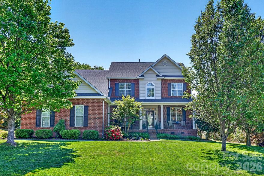 Beautifully maintained home with inviting curb appeal and a covered front porch. A dramatic two-story foyer opens to a private office with French doors and an elegant dining room featuring a trey ceiling, detailed moldings, and classic wainscoting. The versatile main-level bedroom offers the perfect flex space for guests or additional workspace. The main living areas showcase high ceilings and durable luxury vinyl plank flooring, anchored by a spacious great room with a cozy gas log fireplace. The expansive kitchen is designed for both everyday living and entertaining, complete with quartz countertops, a glass tile backsplash, large island with breakfast bar, stainless steel appliances (refrigerator included), and a bright breakfast area. A well-equipped laundry room with cabinetry and shelving adds convenience. Upstairs, the primary suite is a true retreat with a trey ceiling, private sitting room with gas log fireplace, and a beautifully renovated bath featuring an oversized frameless glass tiled shower, quartz dual vanities, and a generous walk-in closet. Secondary bedrooms are spacious and share a hall bath with dual sinks. An oversized bonus room with closet offers flexibility as a sixth bedroom, media room, or play space. New carpet throughout bedrooms, hallway, and stairs. Enjoy outdoor living on the screened porch overlooking a private backyard with raised garden beds and a peaceful wooded backdrop. The three-car garage includes built-in cabinets and shelving for ample storage. Community amenities include a clubhouse, pool, playground, pond, and scenic walking trail surrounding a stunning nationally registered Willow Oak tree. Zoned for sought-after Sandy Ridge Elementary and Marvin Ridge Middle & High Schools, noted for their strong performance and favorable GreatSchools.org ratings (buyer verification recommended). One-year home warranty provided. Don’t miss this one!