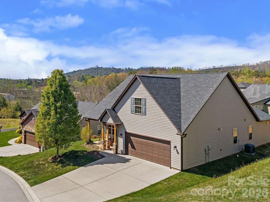 Just minutes from the charm of Downtown Weaverville and the scenic beauty of Lake Louise, this 3-bedroom, 2-bath home offers the ease of one-level living in the established Maple Trace community, set within the highly regarded Reems Creek Valley, where mountain views add a beautiful sense of depth to the setting. With the Blue Ridge Parkway just a 10-minute drive away, you’re perfectly positioned to enjoy some of Western North Carolina’s most iconic scenery at a moment’s notice.

Inside, the home opens to a light-filled interior that feels instantly welcoming. A coffered ceiling draws your eye upward in the main living area, while recessed lighting and natural light work together to create a warm, inviting atmosphere throughout. The living, dining, and kitchen spaces flow together with ease, creating a layout that feels open without ever losing its sense of comfort. 
The kitchen is crisp and thoughtfully arranged, with clean-lined cabinetry, generous workspace, and open shelving that adds just the right amount of character. It connects seamlessly to the dining area and extends out to the covered back patio, where indoor and outdoor living come together naturally, inviting you to enjoy enchanting sunsets while overlooking a spacious, level backyard that offers endless possibilities for gardening, play, or simply relaxing in the peaceful surroundings

The primary suite offers a quiet place to recharge, with a tray ceiling, spacious layout, and an en-suite bath featuring dual vanities and a walk-in shower. Two additional bedrooms provide flexibility for guests, work, or whatever your needs may be.

With Asheville just a short drive away, this home offers a balance of comfort, convenience, and connection to the lifestyle that draws so many to this area.
