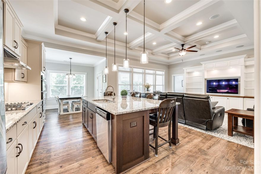 Nestled in a backdrop of trees w/ views of Fishing Creek Lake, & the 13th hole of the Edgewater golf course behind, this immensely upgraded & exceptionally maintained home will leave you nothing short of impressed! Over $57k of upgrades added since build, incl a fenced paver patio & retaining wall to maximize the yard, Eze-Breeze style windows added to screen porch, generator, built-in entertainment center & more (see attached list). A rocking chair front porch w/ views of the lake greets you, & there is a guest suite w/ bath upfront, & a sitting or dining space offers flexibility! The kitchen boasts gas cooking, expansive island table, & details like under cabinet lighting & soft close. No expense was spared at time of build, & everything from a 3 car garage, tankless gas hot water heater, coffered ceiling, surround sound, & more was included! Edgewater is a resort style community w/ amenities galore, incl golf, pool, sport courts, clubhouse, community activities, & the list goes on!