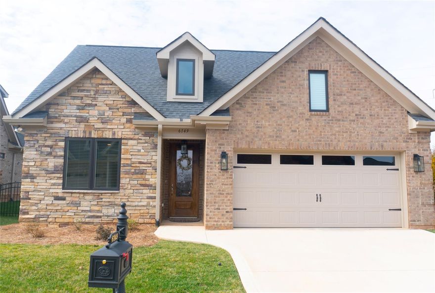 Gorgeous full brick home with stone accent in the desirable maintenance free community of the Springs at Westport. This 3 bedroom 2 bath home has it all...built with many features just like a model home and it's only a year old. Features include quartz counters in the kitchen, SS appliances including a gas cook top / double oven / wine fridge, site finished hardwood floors throughout, a large walk in tile shower in the owner's suite, built in custom closet in the owner's closet, tankless hot water heater, vented gas fireplace, an abundance of moldings and much more. This open floor plan is great for entertaining...the kitchen looks out over a large island into the great room and onto the covered porch in your private courtyard. Complete privacy out side with a fenced in yard and nothing behind you other than a 20 foot berm.  Additional storage over the garage. Amenities that are available are; golf course, clay tennis courts, pickle ball courts, pool, fitness, clubhouse.