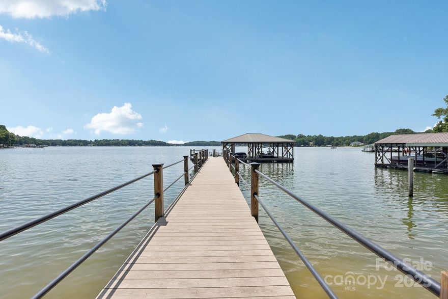 Welcome to a once-in-a-lifetime Lake Norman retreat! This dreamy lake cottage sits on a rare .84-acre point lot with jaw-dropping sunset views that stretch wide across the open water. Enjoy the luxury of an updated private pier, rare covered dock, and two covered boatslips — a true waterfront gem. Inside, you’ll find 4 bedrooms and 3.5 bathrooms with fresh, stylish updates throughout: new luxury vinyl flooring, newly painted interior & exterior, an updated kitchen, and beautifully renovated bathrooms, not to mention brand-new garage doors and a new & freshly paved driveway. This property blends lake life, privacy, and charm into one perfect package. Whether it’s your weekend escape or forever home or it would make a great investment opportunity for a waterfront rental.