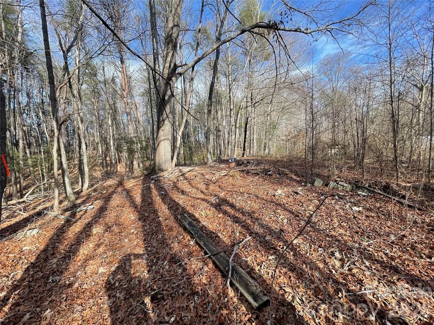 LOT 2 ON THE SUVEY. Flat, easy to clear land in a convenient location. Only 5 minutes to downtown Black Mountain or Swannanoa which is getting a serious redo after Helene. This lot has a 20’ right away you will see in survey for driveway of lot 1. *there are a total of 3 lots available. Each lot is being sold separately or you can buy all 3. (If interested in all 3 lots reach out to agent for price). *Manufactured singlewide of no value transfers (very old and dilapidated, will be easy to get rid of). *You will see a "no trespassing sign", that's only for the neighbors lot, NOT THE LOTS THAT ARE FOR SALE. You have permission go past that sign and park to the left of the first for sale sign... just don't park on neighbors land. Buyer to confirm utilities. Seller is motivated!