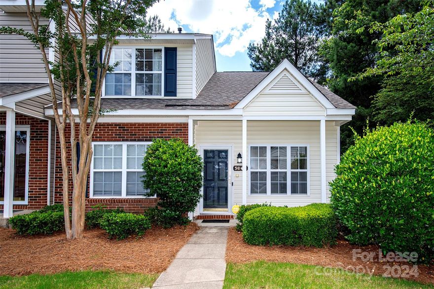 Charming end-unit townhouse with primary bedroom on the main level.  Home offers a front porch and a private rear patio, perfect for relaxation. Freshly painted and featuring new vinyl plank flooring on the main level.   Open and spacious floor plan with plenty of natural light. Cozy two story living room with gas log fireplace.  The kitchen offers ample counter space and the bedrooms are standard size.  One of the bedrooms has a balcony feature that overlooks the living area.  Two assigned parking spaces and several guest parking closeby.  Landlord covers $50/month of water bill.  Easy commute to UNCC, Uptown Charlotte, PNC Pavilion, Charlotte Motor Speedway. Minutes away from interstates: I85, I485. Each adult (18+) needs to fill out the application. Acceptance is based on approval subject to credit, income, background, and rental history. References required.