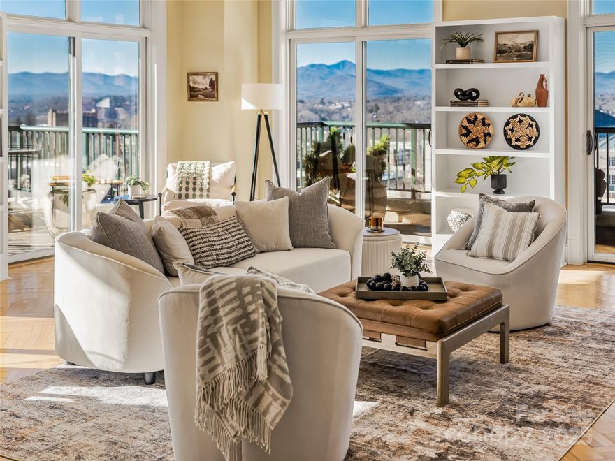 Experience elevated downtown living in this beautifully updated corner residence on the top floor of one of Asheville’s premier condominium buildings. With no unit above and multiple balconies capturing panoramic mountain and city views, this home offers one of the most impressive vantage points in all of downtown.
Freshly painted throughout, the condo features upgraded kitchen and bathroom countertops, herringbone wood floors, natural gas fireplace, custom tile, motorized window shades throughout, and a striking gallery wall that creates a warm, artful welcome the moment you step inside. Major mechanical updates include a new hot water heater and brand-new HVAC system on order, offering peace of mind and long-term value.
The spacious layout includes a large laundry room, generous storage, and easy access to the mountains on the private balconies—ideal for enjoying your morning beverage or a sunset evening overlooking Asheville’s historic skyline, including the iconic Flat Iron Building directly across the street.
Residents of 21 Battery Park enjoy exceptional amenities:
- Rooftop terrace with year-round mountain and city views
- Indoor climate-controlled parking in the secure garage
- Workout facility and clubhouse for gatherings
- Two elevators for convenience and accessibility
- Trash chutes on every floor and recycling drop off on main
- Quiet, impeccably maintained common areas, cleaned daily.
Step outside your door and explore downtown Asheville’s best dining, boutiques, galleries, live entertainment, theater, and the new Asheville Forager Market—all just an elevator's ride away.
This corner residence combines luxury, convenience, privacy, and one of the most desirable locations in the city. 
Copy and Paste this link for a virtual walkthrough inside Unit 702: https://bit.ly/4axWs38