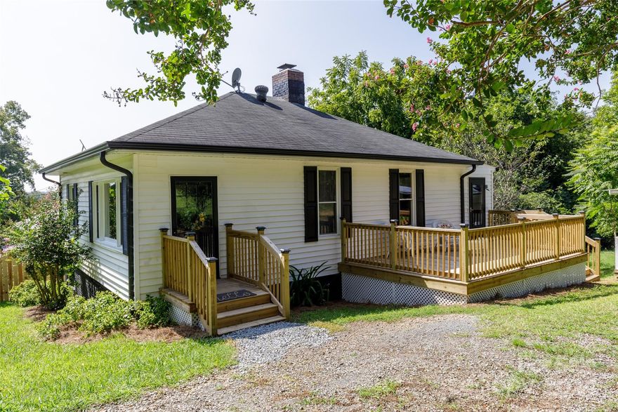 Discover serene living in the charming Uwharrie region, just northeast of Charlotte, in the historic Town of Badin. Enjoy easy access to Falls Road, leading to Falls Reservoir on the Yadkin River, perfect for boating, paddling, and admiring the Uwharrie Mountains' lush forested slopes. Badin Lake and Morrow Mountain State Park are also nearby, offering opportunities for boating, hiking, horseback riding, paddling, swimming (seasonal pool), fishing, outdoor meals, and camping.

This newly renovated two-bedroom, two-bath bungalow features a large kitchen with ample dining space and a spacious living room with a generous picture window for abundant natural light. Situated on a .41-acre lot, the property includes multiple fenced areas, an expansive deck, a one-car garage or shed, and two carports. With a commute to Charlotte of less than an hour, this home is a perfect blend of tranquility and convenience. Come explore this gem and make it yours today!