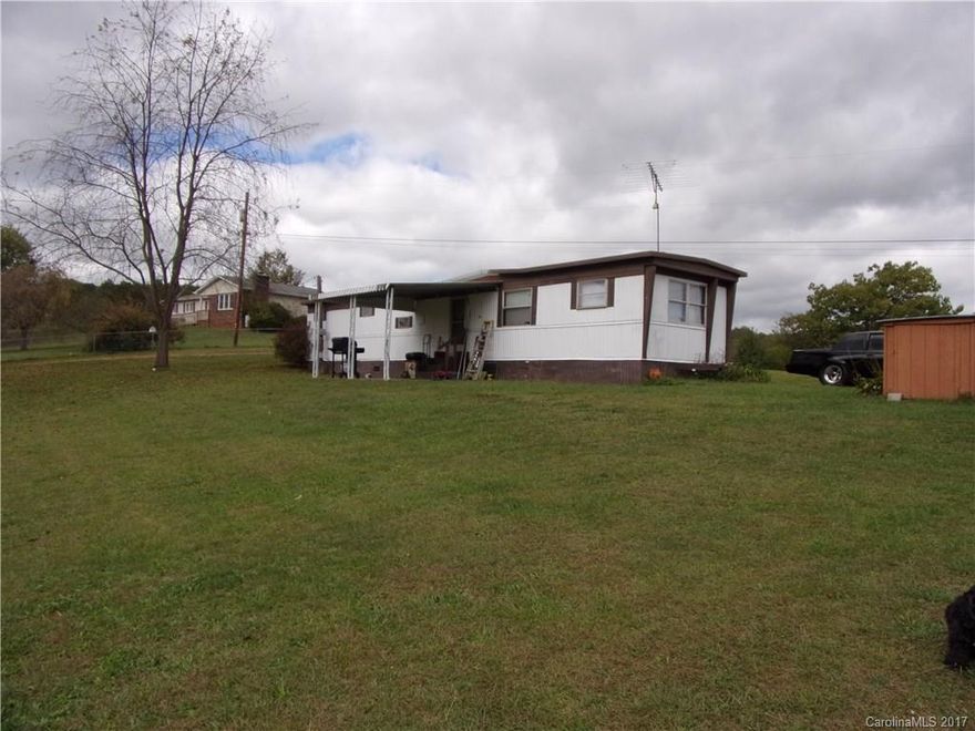 2 bedroom 1 bath on .79 level acres with large workshop.