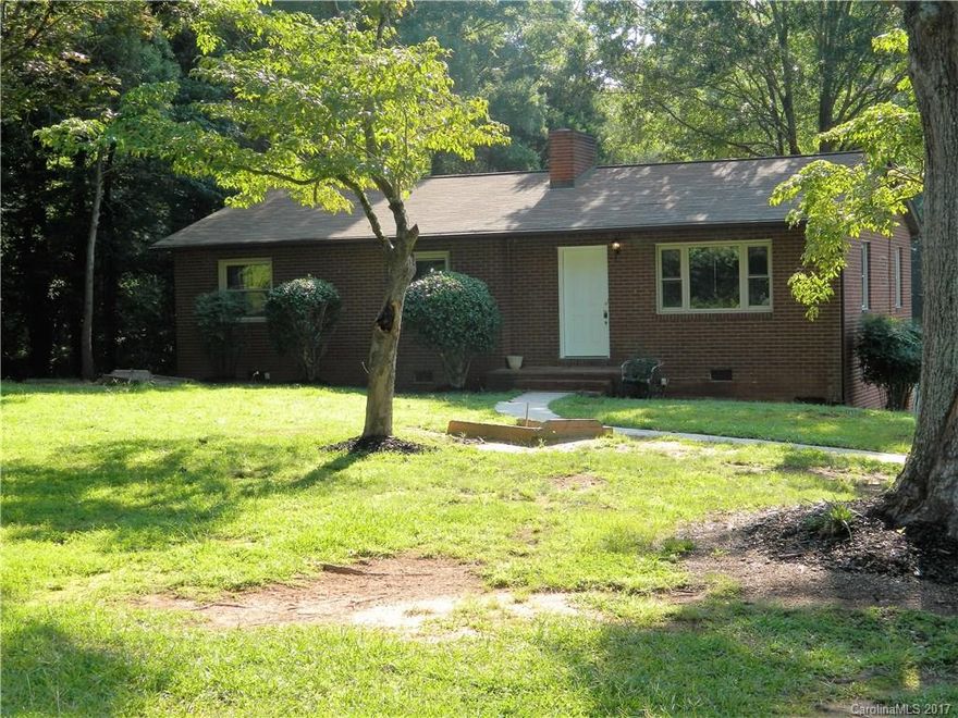 Come see this move in ready 3 bed 1 bath home in a mature section of Charlotte. Beautiful hardwood and tile floors.  open kitchen with upgraded back-splash.  Fresh paint both inside house and deck.  Huge lot of over an acre with a massive detached garage/workshop/? use your imagination.  it has room for 4 cars plus, an office and bathroom. Tenants have been there for almost 8 years paying $850/month.  They would love to stay but understand new owner may want to occupy and are prepared to leave.