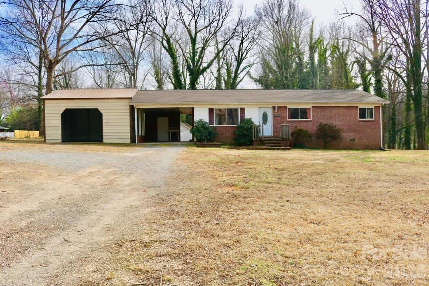 Welcome home to this charming brick ranch nestled on a large, open lot with beautiful mature trees that provide privacy and a peaceful setting. This well-maintained home features classic brick exterior, a welcoming front entry, and plenty of natural light throughout. The heart of the home is an open living area that flows directly into a roomy kitchen — perfect for family time and entertaining. New paint throughout the home. 

The property includes a large detached garage/workshop and a covered carport, offering plenty of space for vehicles, storage, hobbies, or equipment. The expansive yard provides endless possibilities for outdoor living, gardening, or entertaining. Entering from outside to downstairs, you will get a large, clean unfinished basement to use as storage, workshop, or to finish into additional living space — huge value for the buyer who wants added square footage.

Conveniently located in hickory 10 minutes from all shopping areas while still offering a quiet, country-like feel, this home is perfect for anyone looking for space, comfort, and potential. Schedule a showing today — this one won’t last long!