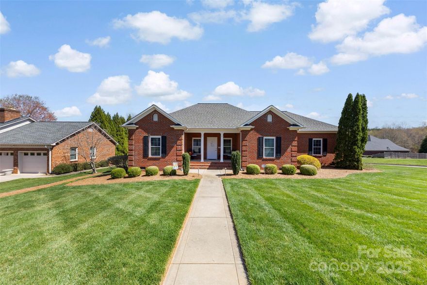 Welcome to this beautifully crafted custom-built brick ranch, nestled in a serene and peaceful Eastside neighborhood with no through traffic. Located on a prime corner lot, the lush, meticulously landscaped yard immediately draws attention, showcasing the pride of ownership. Step outside to your large, covered back porch—perfect for enjoying the tranquil rear yard at any time of day. Whether you're sipping coffee in the morning or unwinding in the evening, this outdoor space provides an ideal retreat. Inside, the classic interior exudes warmth and comfort. A spacious and open family room invites gatherings, while the large kitchen boasts updated appliances, sleek Silestone countertops, and ample cabinetry for all your culinary needs. Beautiful hardwood floors flow seamlessly throughout living areas adding to the home's elegance. The versatile laundry room, which also functions as a study area, is complete with a sink and a convenient extra walk-in pantry—ideal for extra storage.