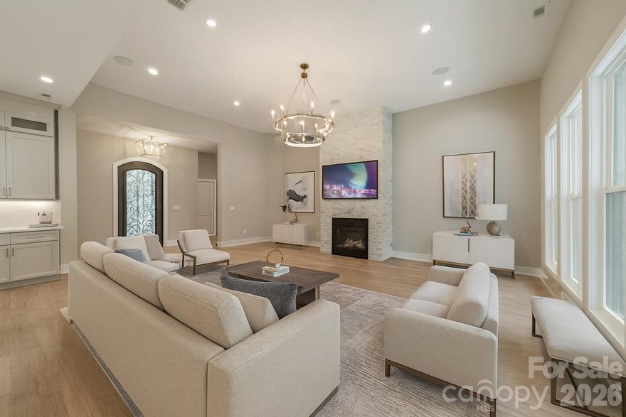 Welcome home to your stunning Lake Norman retreat—where luxury, privacy, and modern elegance come together on over an acre of pristine lakefront property. Nestled on 1.30 acres in the sought-after Norman Pointe community, this exceptional 5-bedroom, 3 full bath, 2 half bath estate sits peacefully at the end of a quiet cul-de-sac.

A long, private driveway welcomes you to this remarkable home, complete with a spacious 3-car garage and surrounded by the natural beauty of the lake. Inside, the main level offers an open-concept design with soaring 12-foot ceilings, rich hardwood and marble tile flooring, custom lighting, and a striking stone fireplace that anchors the living space.

The expansive primary suite is a true sanctuary, perfectly positioned to capture serene lake views. The spa-inspired bathroom features elegant marble finishes, and with an accepted offer, the seller will tailor the custom closet to suit your personal style. At the heart of the home, the chef’s kitchen impresses with an oversized quartz island, custom cabinetry, and premium appliances—ideal for both everyday living and entertaining.

The walk-out basement is designed for enjoyment and hosting, featuring a large bonus room pre-wired for a home theater or game room, a wine cellar, two wet bars, and a spacious living area that opens to a flat, expansive backyard—ready for the pool you’ve always envisioned.

Step outside to your private dock and enjoy direct access to Lake Norman, along with community amenities including RV and boat storage. This is lakefront living at its finest.

Schedule your private tour today and experience everything this extraordinary Lake Norman estate has to offer. Some listing photos are virtually staged, including the pool rendering.