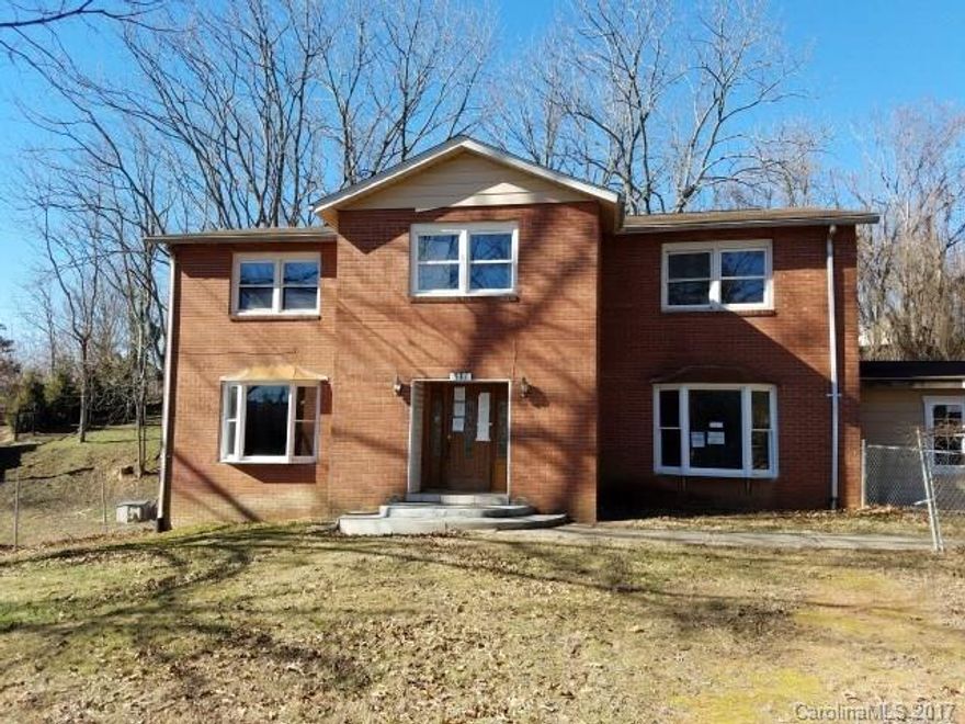 Fixer upper in Downtown Asheville location! 4 BR, 2.5 BA, three separate living areas, fireplace, and over 3,000 SF, attached workshop, level 0.49 acre lot, paved driveway. Seller and listing agent make no representations or warranties. Sold "as is". Seller will not turn on water & gas. Buyer to conduct all inspections. Proof of funds or prequal letter required with offers.  See attachment for instructions on submitting an offer. Because of condition, cash offers only.