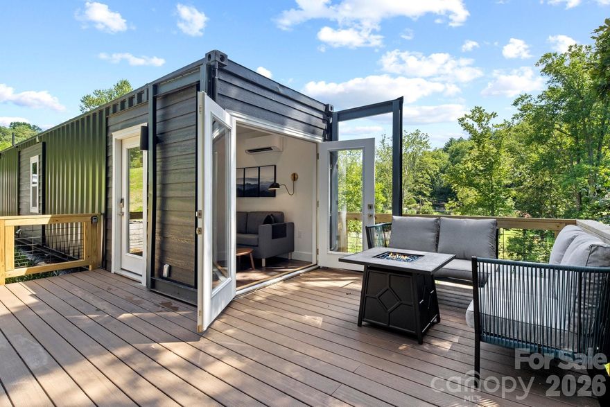 Own a rare modern container retreat just minutes from Asheville—with two designer tiny homes, Pearl (10) and Onyx (9), available individually or together for a unique lifestyle or investment opportunity.

Onyx Container Home offers a thoughtfully designed modern retreat that blends contemporary style with low-maintenance living. This stylish tiny home features a comfortable queen bedroom, a sleek and efficient kitchen with all the essentials, and a beautifully maintained full bath.

Outdoor living is a highlight, with a spacious main deck ideal for relaxing or entertaining, plus a private deck off the bedroom—perfect for morning coffee or evening stargazing. The intentional design and inviting atmosphere create a distinctive experience that appeals to both homeowners and short-term rental guests alike.

Pearl is one of two container homes available on separate parcels—Pearl and Onyx. Each property may be purchased individually or together, offering flexibility for buyers seeking a private mountain getaway, an income-producing short-term rental, or the opportunity to expand a portfolio with two complementary properties in a desirable location.

Whether used as a personal retreat or investment property, this unique container home provides a memorable stay experience just minutes from everything Asheville has to offer—renowned dining, vibrant arts, and endless outdoor adventure.