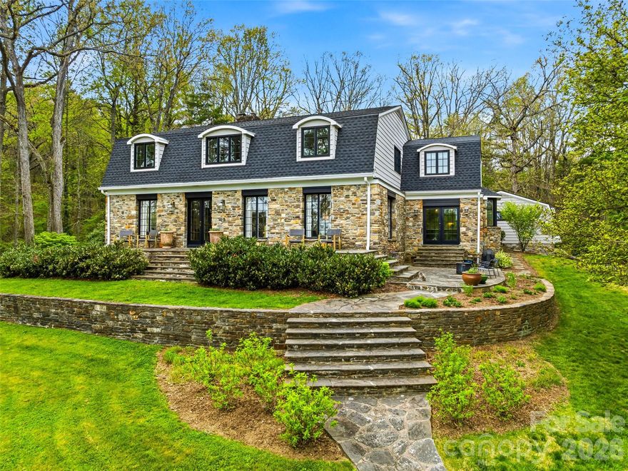 A rare legacy estate offering an extraordinary blend of historic character and refined modern living, this 5,800 sq ft residence is set on 10.88 private acres just minutes from downtown Hendersonville. Thoughtfully updated with all major systems renovated since 2014, the home preserves its architectural integrity while delivering effortless comfort. Five bedrooms, 4 full and 2 half baths—including a private guest wing—provide space for both intimate living and elegant entertaining. Long-range mountain views, established walking trails, a resort-style pool, and multiple outbuildings create a setting of exceptional privacy and versatility. A truly rare opportunity to own a timeless estate in one of Western North Carolina’s most desirable locations.