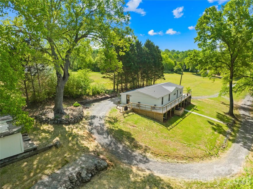 Tucked away in the quiet charm of Claremont, NC, this fully remodeled retreat offers something truly rare—peaceful living with the soothing backdrop of a nearby waterfall, all for under $250K. With only two neighboring homes, privacy and tranquility take center stage.
Start your mornings or unwind in the evenings on the expansive full-length deck, where the gentle sound of cascading water creates a setting that feels miles away from it all. Thoughtfully redesigned for comfort and accessibility, the home features a near zero-step entry with both a single-step access point and ramp.
Inside, you’ll find a fresh, modern interior from top to bottom. Luxury vinyl plank flooring flows throughout, complemented by updated textured ceilings and stylish shiplap accents. The open-concept living space is anchored by a beautifully renovated kitchen featuring new cabinetry, butcher block countertops, and stainless steel appliances—perfect for everyday living or entertaining.
The layout offers ideal separation, with two secondary bedrooms and a spacious full bath on one side, while the primary suite is privately positioned on the other. Designed with relaxation in mind, the primary retreat feels like a spa—complete with its own exterior access, a soaking tub, and a walk-in closet.
Don’t let the home’s original age fool you—this property has been completely rebuilt and upgraded. With a pre-listing inspection already completed and repairs addressed, you can move in with confidence. Major improvements include new board and batten siding, a new roof, HVAC system, and enhanced insulation for energy efficiency.
Situated on approximately half an acre, the property also includes a 40-foot-wide deeded easement stretching from the driveway down toward Ringtail—ideal for a future garden, additional parking, or extra usable space.
Conveniently located near major highways and nearby towns, this one-of-a-kind property blends modern updates, natural beauty, and everyday convenience. A home like this isn’t just seen—it’s experienced.