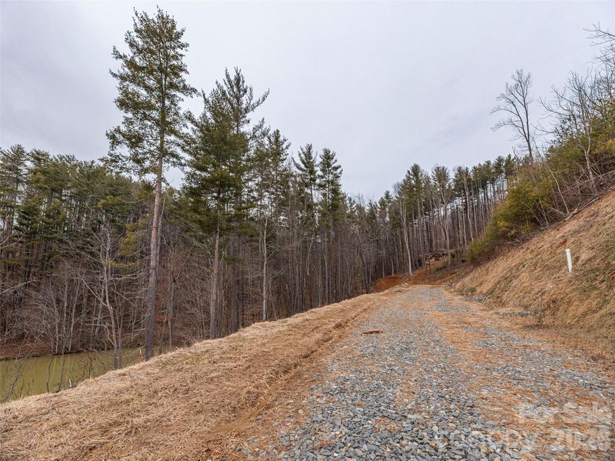 This exceptional lot at The Views at Masters Landing offers a prime setting within Maggie Valley Club & Resort, a waterfront parcel in a stunning mountain setting. Positioned to enjoy peaceful surroundings and scenic views, the property provides an ideal canvas for a thoughtfully designed custom home built with Distinctive Building & Design. Ownership includes Maggie Valley Club membership with access to its amenities, along with the convenience of city water and sewer, underground utilities, high-speed internet, and excellent accessibility—making this lot a perfect blend of natural beauty and modern convenience in an upscale development.