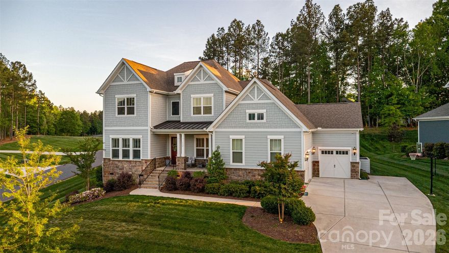 Located in the highly sought-after McLean South Shore community in Belmont, North Carolina, this beautifully designed 2021-built home is offered at $980,000 and captures the essence of refined lake living.

From the moment you arrive, a charming front porch welcomes you—perfectly positioned to take in serene lake views, setting the tone for both relaxed mornings and quiet evenings.

Inside, the main level features an open-concept layout where the living room, kitchen, eat-in area, and dining room flow seamlessly together. A striking stone gas fireplace anchors the space, creating a warm and inviting focal point for everyday living and entertaining alike. Just beyond, a spacious screened back porch and open deck extend the living area outdoors.

The main-level primary suite offers a true retreat, complete with a spa-inspired bath featuring a soaking tub, standalone shower, and an oversized closet designed to impress—with a center island that brings both function and luxury together effortlessly.

Upstairs, you’ll find three additional bedrooms, two full bathrooms, and a versatile bonus room with a built-in Murphy bed—ideal for guests, a home office, or flexible living space.

Additional highlights include a three-car garage and thoughtfully designed spaces throughout that balance comfort and style.

Beyond the home, McLean South Shore offers an exceptional lifestyle with a community clubhouse, outdoor pool, playground, and scenic walking trails. You’re also just a short golf cart ride away from Drift on Lake Wylie—perfect for an easy lunch or sunset dinner.

With water views, access to two nearby boat launch points, and a setting that blends natural beauty with everyday convenience, this home offers a truly elevated living experience.