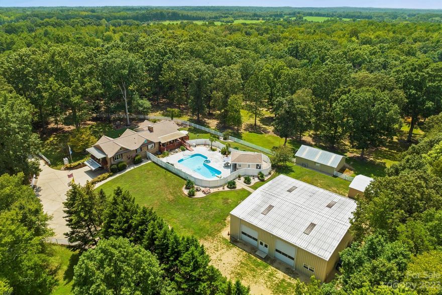 BRING ALL OFFERS! A picturesque country estate situated on 8+ acres just minutes to the Mineral Springs Greenway. This charming horse lovers delight offers a sense of privacy while maintaining easy access to countless nearby amenities only minutes to downtown Waxhaw. Come inside the gated entrance with stunning white fencing that surrounds the property giving it the supreme privacy you’re looking for. Nestled under the shade trees this 1 story basement home showcases an in ground pool and pool house. Endless opportunities for the new owner to make this gem their own piece of heaven. Meticulously maintained grounds showcases equestrian amenities including a 36x24-2 stall barn w/room to make 4 stalls, 24x24 metal building for hay/storage, 3 pastures-fenced separately, 60x60 shop building w/2 horse stalls-space for your RV, pond with gazebo, Generac Whole House Power System. A piece of paradise that has it all! See attached special features list for additional property details!
