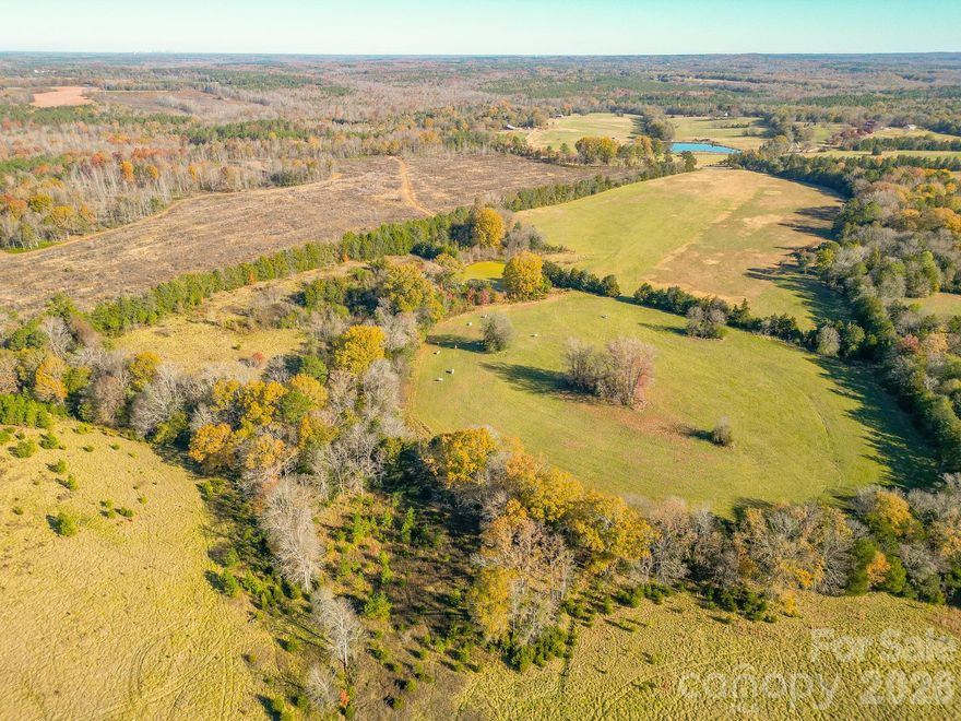 Discover a true hidden gem — 84.67 breathtaking acres in Lancaster County with endless opportunity and unmatched potential. Featuring approximately 1,775 ft of frontage on Culp Ferguson Road and 2,175 ft on Porter Ranch Road, this expansive parcel is ideal for investors, developers, farmers, ranchers, horse enthusiasts, or anyone dreaming of a family compound.

This stunning tract offers a beautiful mix of features to suit multiple uses. Enjoy wide-open fields, fenced pastures, and gently rolling topography blended with mature wooded buffers that create a peaceful sense of privacy throughout the property. Several large cleared areas provide excellent potential homesites, agricultural zones, or development layouts. A scenic pond adds to the natural charm and provides a perfect focal point for future recreational use or a picturesque homesite.

Whether you envision building several homes, building out your ideal horse property or livestock-friendly homestead, creating a recreational retreat, or simply securing land in a rapidly growing area, this property checks every box. The layout, road access, and variety of terrain offer exceptional flexibility for nearly any vision.

Conveniently located just minutes from shopping, dining, and daily conveniences, the property provides easy access to US-521, US-5, I-77 and Hwy 9 Bypass providing a quick route to Van Wyck, Indian Land, Lancaster, Rock Hill, and Charlotte.

Opportunities like this are few and far between — don’t miss your chance to own one of Lancaster County’s most versatile and picturesque large-acre parcels.