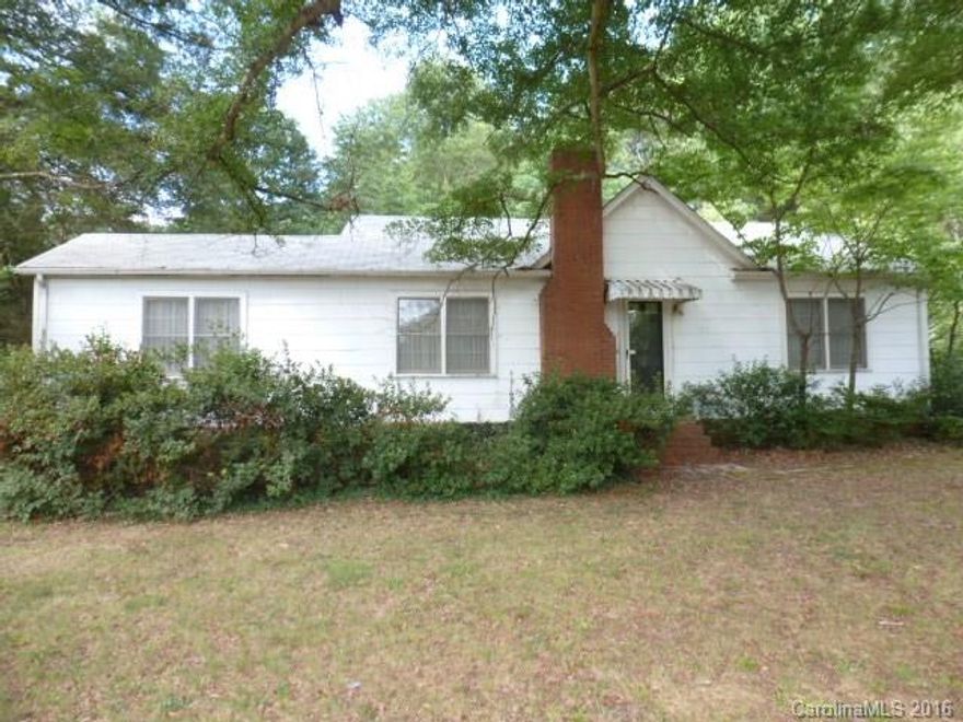 Great location, close to all Lancaster amenities, and close to Rock Hill and Charlotte. New roof in 2011. This 2BR, 1BA home features, Fml living room, fml dining room, den with fireplace, large kitchen with pantry, lots of cabinets, all appliances remain. Hardwood under carpet. Single detached garage, all on over 4 acres of land.