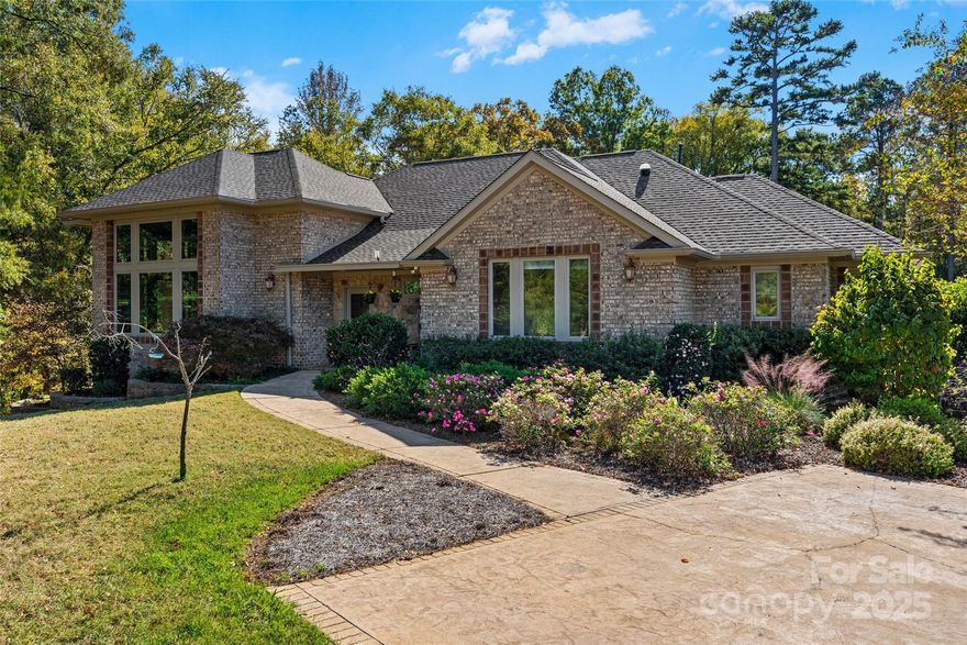 Private. Large. Luxury. Unique. Handicap Accessible. Electric Car Charging Station. Endless possibilities. Rock Hill. This custom built home by Tom Johnson will take you by surprise and yet make you feel completely at home.  Tucked away  in a cul-de-sac on 3 acres, this beautiful 3 bedroom, 3.5 bath home will delight you with its soaring ceilings and large stone fireplace.  If you want windows to bring the outside in, there are large, premium windows galore as well as 4 sky tubes that bring the sunshine in even when the lights are not on.  This home is a wonderful split bedroom plan with an upstairs bonus room with full bath and a  large heated basement that make it even well-suited for multi-family living.  The primary bedroom has French doors that open to the back deck and the bathroom has a walk-in shower and two separate sinks and two separate closets. The two main bathrooms have heated tile floors. The gourmet kitchen is is surrounded in solid maple cabinets, and hosts a  gas cooktop with vent hood, incredible pantry storage, an industrial sized sink and it will be ready to work when you bring in fruit and vegetables from the garden area, the vineyard, the container beds and the fruit trees on the property.  You will even find a small storage room in the basement for canned vegetables or wine. When you are tired from gardening, a small, salt water-chlorine generated pool, patio, deck areas and a fountain welcome you to rest and relax.  Extra-special home. Don’t miss it.

Other features:
Oversized Two Car Garage, Water Softener on Well, Yearly Termite Inspections, HVAC under Service Plan, Front Porch, Large Yard, Tons of Storage, Natural Gas Fireplace,  Convenient Location in Rock Hill, Built-in Kitchen Storage Cabinets, Custom Closets Throughout, Stamped Concrete Driveway, Ramp in Garage, Septic Pumped in 2022, New Roof in 2024.
