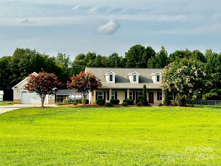 A picture perfect country setting awaits on this beautiful 5 acre property framed by a beautiful black wooden fence. Setting back off the main road, you're welcomed down the driveway by green pastures and crepe myrtle trees. The home has covered porches on the front and side and a covered patio in the back. In addition to the 2 car garage attached by a covered breezeway, there is another 2 bay 28x30 shop in the back with two 12 foot lean to's on each side, two 18x20 storage buildings, a chicken coop and goat pens. The property has no restrictions and is completely fenced in so horses or other farm animals are welcomed! Inside, the home has a split floorplan with a large master suite with high treyed ceilings and a private bath. The living room features a vaulted ceiling and hardwood floors. The eat in kitchen has beautiful black granite countertops and comes with all appliances. This property is a charmer so schedule your showing today!
