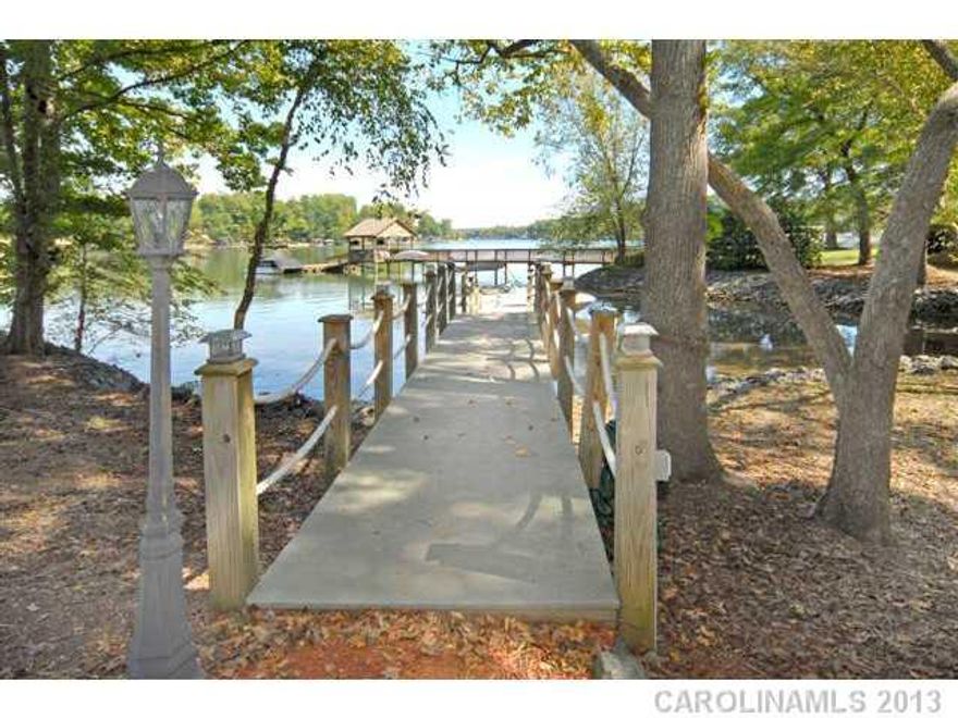 Waterfront Home with finished Walk Out Basement in highly desired family-oriented neighborhood.  5 Bedrooms, plus Home Office Area, a Huge Recreation Room & a Gathering Room on the top level.  Screened Porch, Decks and Water  View Hot Tub & Floating Dock.  All on Quiet Street.  335 Sq. Feet of unfinished space in basement. Close to Shopping & Restaurants. Clover Schools, Low SC Taxes. A Must See!!