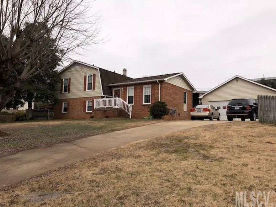 ONE OWNER HOME LOVINGLY MAINTAINED! 4 Bedroom 2 bath Tri-Level home with approximately 2000 hsf. Huge open kitchen with island and tons of quality cabinetry. Pergo floors look like hardwoods. Large, open dining room off kitchen flows to living room. 3 bedrooms and large bathroom--private access to the main bedroom. Downstairs is a den with a fireplace/gas logs, a huge master bedroom with walk-in closet and bathroom. Laundry room also on bottom level. Private covered porch off kitchen and privacy fence in back yard! Very nice covered breezeway to walk from double detached garage into house. Garage is heated with natural gas monitor and cooled with window unit. Almost another living quarters there! New heat pump, new roof, new vinyl siding, some new appliances, window replacements! This is a great value for the money! A must see!!