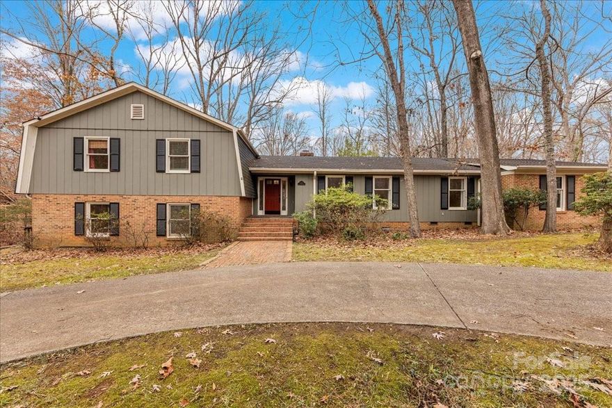 Incredible investment opportunity on a one-acre corner lot in coveted Providence Plantation. This tri-level home offers over 4,000 square feet of heated living space and has been well maintained throughout. The main living area showcases beautiful hardwood floors, a charming family room with gas logs, and a kitchen with updated cabinets and countertops. This level also includes a formal living room, dining room, and a flexible space ideal for an office or additional bedroom. The upper level features three oversized bedrooms, including the primary suite with a renovated en-suite bathroom. The walkout lower level boasts a spacious open floor plan with a wood-burning fireplace, a second primary suite including a fully renovated full bathroom, perfect for extended living or entertaining space, and it's own interior/exterior entrance. The home is connected to city water and also features a private well that supplies the exterior spigots, ideal for watering the yard and washing cars.