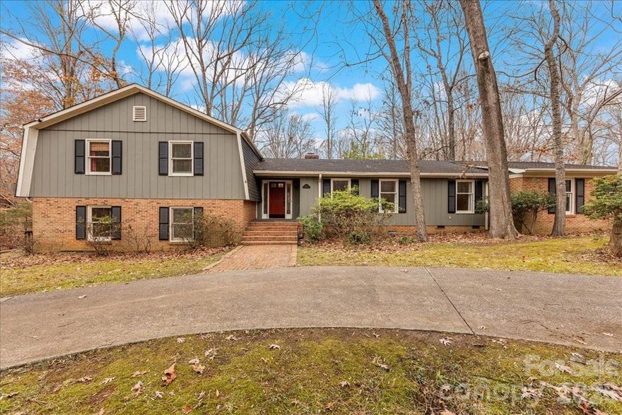 Incredible investment opportunity on a one-acre corner lot in coveted Providence Plantation. This tri-level home offers over 4,000 square feet of heated living space and has been well maintained throughout. The main living area showcases beautiful hardwood floors, a charming family room with gas logs, and a kitchen with updated cabinets and countertops. This level also includes a formal living room, dining room, and a flexible space ideal for an office or additional bedroom. The upper level features three oversized bedrooms, including the primary suite with a renovated en-suite bathroom. The walkout lower level boasts a spacious open floor plan with a wood-burning fireplace, a second primary suite including a fully renovated full bathroom, perfect for extended living or entertaining space, and it's own interior/exterior entrance. The home is connected to city water and also features a private well that supplies the exterior spigots, ideal for watering the yard and washing cars. Some photos include virtual staging for illustrative purposes.