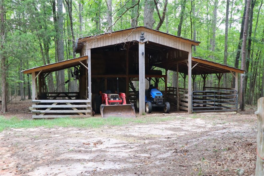 Peaceful wooded and fenced land with wide trails cut throughout the property. Beautiful barn with hay loft and many possibilities for creating stalls/run ins for animals - perfect for storing tractor equipment. Chicken coupe already built inside barn area (can be removed) and ready for your chickens. Land lays perfectly and has many places where you can build you dream home privately and enjoy nature at its very best! NO HOA. Deed restrictions: no mobile or modular homes/1450 min sq. heated sq. ft. Over 600 ft. Road frontage.