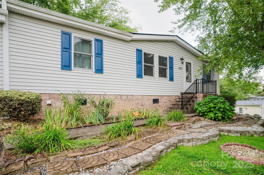 Move in ready and the seller has done many recent updates to make this a solid home for the next owner! Conveniently located, well maintained home in quiet 55+ community! This two bedroom/ two bath with recently installed new roof, new windows, new plumbing, new hot water heater, new interior paint, updated electrical system and pumped septic. See attachment for list of all repairs and renovations. All appliances convey including washer and dryer. This spaceous open floor plan includes a bonus sunroom for reading or watching nature, and a garage with workshop space. The Cumberland Village community features a community use meeting space/clubhouse, outdoor pool which as been newly renovated and is now chlorine free, walking areas and provides mowing services with the HOA fee! This bright and adorable home is a well-maintained, affordable option in a retirement community close to the heart of Hendersonville. This is not on a leased lot! The homeowner owns .02 acres and pays no lot rent. New lights installed in the bedrooms and dining room space. Bedrooms have fresh paint as of 11/2025. Come see this fresh, bright and charming home today!