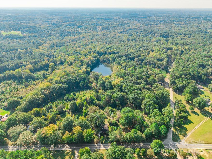 54 of 56 acres being sold with 3 dwellings at no value.  Great for developers!