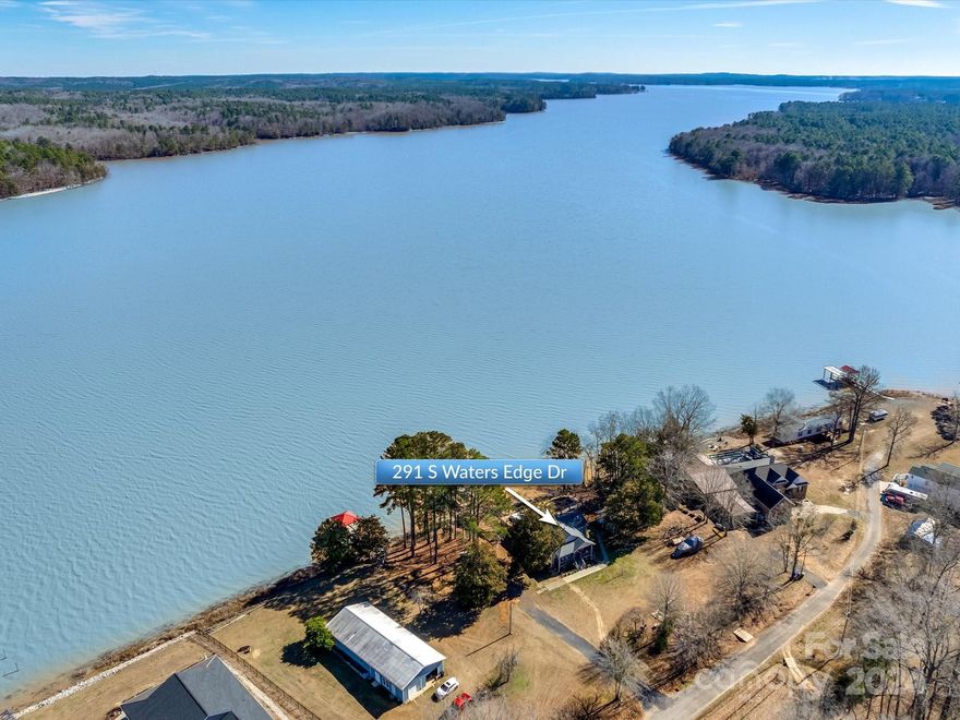 Nestled along the pristine shores of Lake Wateree, this secluded waterfront haven unveils a picturesque retreat, boasting a unique blend of tranquility & luxury. Situated on a generous .77 acre level lot with a gentle slope to the lake, TWO boat lifts, 2-story dock w/impressive upper & lower sundeck! The property is cocooned by scenic views of Liberty Hill Wildlife Management Area & the Winnsboro State Park ensuring an undisturbed sanctuary for those seeking solace amongst nature's beauty. The heart of the home is the gourmet kitchen, adorned w/granite countertops, SS KitchenAid applncs, double oven, gas range (refrigerator conveys). You'll love the luxury vinyl flooring, plantation shutters, 9'ceilings & industrial-style accents throughout the home. The sunroom addition offers great flex space. Enjoy outdoor entertaining with your salt-water pool, gas firepit & expansive newly stained deck. Separate heated/cooled game room! Seller happily commutes to Charlotte for work, stress free!