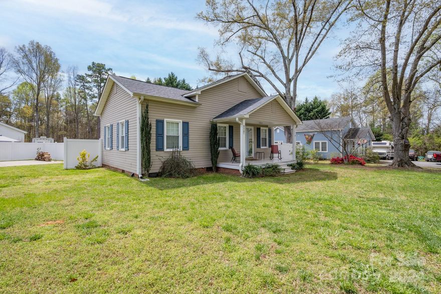 This cute 2 bedroom, 2 bath home is situated on almost a half acre lot close to lake access.  Relax on the covered patio with privacy fencing around, or enjoy working on a hobby in the wired storage building! Newer updates include roof shingles replaced (2023), tankless water heater (2021), and HVAC unit (2019).