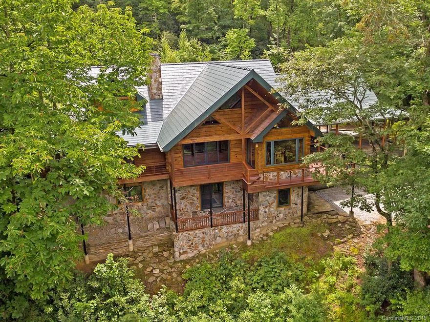 Here is the perfect hidden mountain oasis enfolded within the unsurpassed beauty of the Western North Carolina mountains. This immaculate house directly borders Pisgah National Forest and is exquisitely perched over the West Fork of the French Broad River. Trout fishing’s finest at your feet and a hunter’s dream. A True North Log Home built from Pine logs with Douglas Fir beams and Eastern Red Cedar doors, cabinets and finishes. 90+ acres assure privacy and a deep connection with nature. Soaring ceilings, a stacked stone wall with fireplace stove, sweeping deck, modern Kitchen and main level master suite with a second Minnesota fireplace stove. An easy to maintain home, there is also a detached garage with caretakers quarters above.