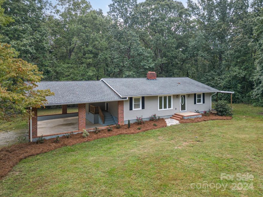 Outdoor Oasis on 2.58 acre lot conveniently located near charming downtown Cherryville with easy access to shops, dining, and local amenities. This newly renovated 2-bedroom, 1.5-bathroom ranch home offers spacious outdoor living amid a serene wooded setting. Inside, enjoy brand-new carpet, refinished hardwood floors, and an open kitchen-dining area, versatile space designed for both everyday meals and special gatherings. Relax in the cozy living room and warm by the welcoming fireplace during cooler evenings. The unfinished basement offers tons of extra storage all centered around a second fireplace. Step outside to a large wooden deck overlooking your gorgeous wooded backyard—ideal for morning coffees or evening relaxation. The spacious front yard with welcoming mature trees near the road offers the ideal place for outdoor family fun. Don't miss out on this upgraded home, conveniently located in a peaceful country location.