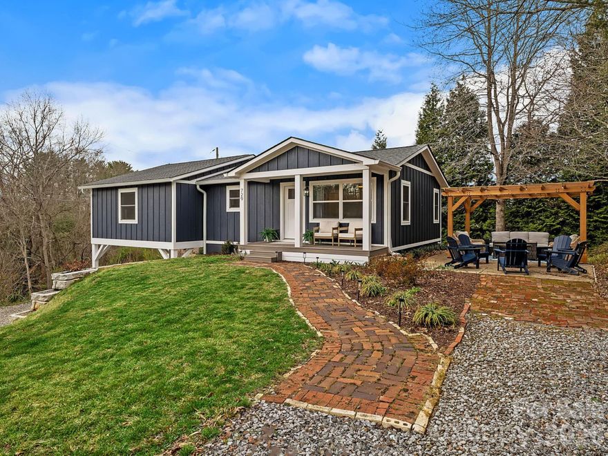 Completely renovated with a focus on quality and design, this one-level Asheville home offers the look and feel of brand-new construction. Every detail has been carefully updated, with curated finishes and fixtures that create a cohesive and elevated feel throughout.

Natural light fills the interior, highlighting wide-plank flooring and a clean, modern aesthetic. The kitchen and dining area are seamlessly connected, forming a functional and inviting space for everyday living and gathering. The kitchen has been beautifully reimagined with stylish cabinetry, quality countertops, stainless steel appliances, and a distinctive backsplash that adds both texture and visual interest.

The living room is set just off the main living areas, offering a comfortable and versatile space to relax while maintaining a natural sense of separation.

The primary suite is spacious and refined, featuring a walk-in closet and a well-appointed bath with dual vanities, a walk-in shower, and a more elevated, luxurious feel. Two additional bedrooms provide flexibility for guests, a home office, or additional living needs, all complemented by a fully updated secondary bath.

Outdoor spaces are equally inviting, with a covered front porch and a patio with pergola that creates an ideal setting for relaxing or entertaining. The yard offers a great balance of usability and charm.

Conveniently located in Asheville with easy access to shopping, dining, and everyday essentials, this home presents a turnkey opportunity with a polished, modern feel throughout.