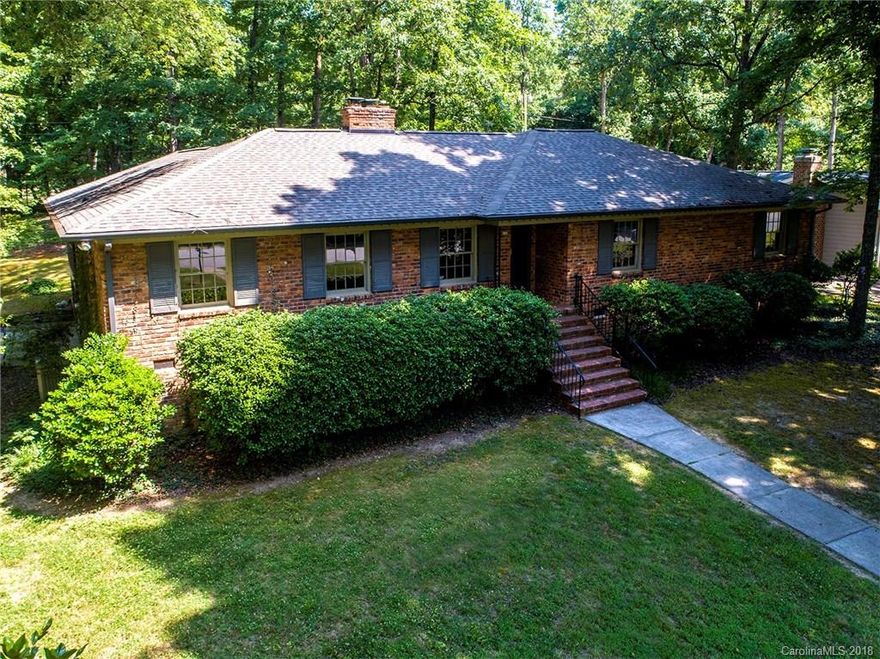 Traditional Brick Ranch with mature landscaping on a private .44 acre lot. This beautiful home features original -beautiful condition - hardwood floors. Living Room with Built-ins and a Fireplace plus a separate Dining Room. Kitchen has granite counter tops and updated appliances and is open to the Breakfast Room. The Family Room features bright neutrally colored and freshly painted walls and the second Fireplace. There are 4 bedrooms and 2 full Baths. Enjoy spending time on the beautiful huge screened porch with tile floor. There is a 2 car carport adjacent to an exterior entrance into a big basement storage/workshop. Many of the rooms have been recently painted. Roof replaced in 2017. Pull down attic with lots of floored area could be used as additional storage. This home is located just a few minutes from the new Publix Grocery Store, Cotswold Shopping Center and easy access to SouthPark and Uptown Charlotte.