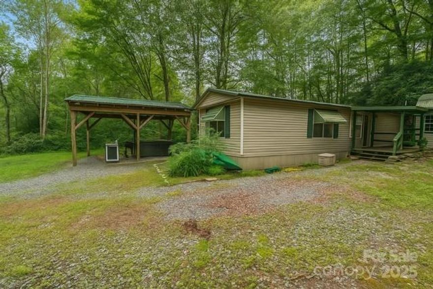 300 feet +/- on the East Fork River on 3.3 unrestricted acres.  This is a rare opportunity!  Trout fish from your own private section of the river, explore the outdoors and create your own paradise!  The 2 bedroom single wide has tons of potential with a screen porch, large picnic area with hot tub, tons of privacy and a river cabin (no power) next to the water.  This home is located minutes from Headwaters State Park hiking trails, great road biking location, 15 minutes from DuPont State Forest and 20 minutes to Pisgah National Forest and downtown Brevard.