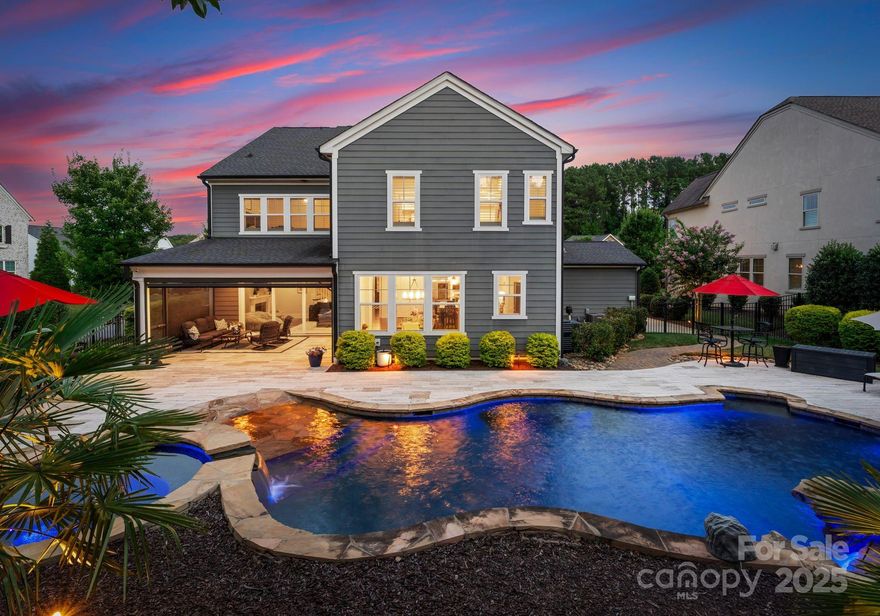 Experience resort-style living in with a move-in ready Classica Homes showpiece. This energy-efficient home features a flagship zero-entry heated saltwater pool and spa by Anthony & Sylvan, with custom tile decking, gas fire pit, and screened porch with retractable mechanical screens for seamless indoor-outdoor living. The open-concept interior stuns with a two-tone kitchen design, eat-in island, Sub-Zero built-in fridge, Wolf appliances, and abundant natural light. A sample of additional upgrades include built-in surround sound, custom closet systems, designer finishes, and a 3-car garage with epoxy floors, storage, and an expanded water heater. Extensive professional landscaping enhances both privacy and poolside enjoyment. Located in a prime Huntersville neighborhood next to the greenway system and just 20 minutes from uptown Charlotte and 10 minutes to Lake Norman and Birkdale Village—this is Classica’s finest craftsmanship with all the added extras and attention to detail.