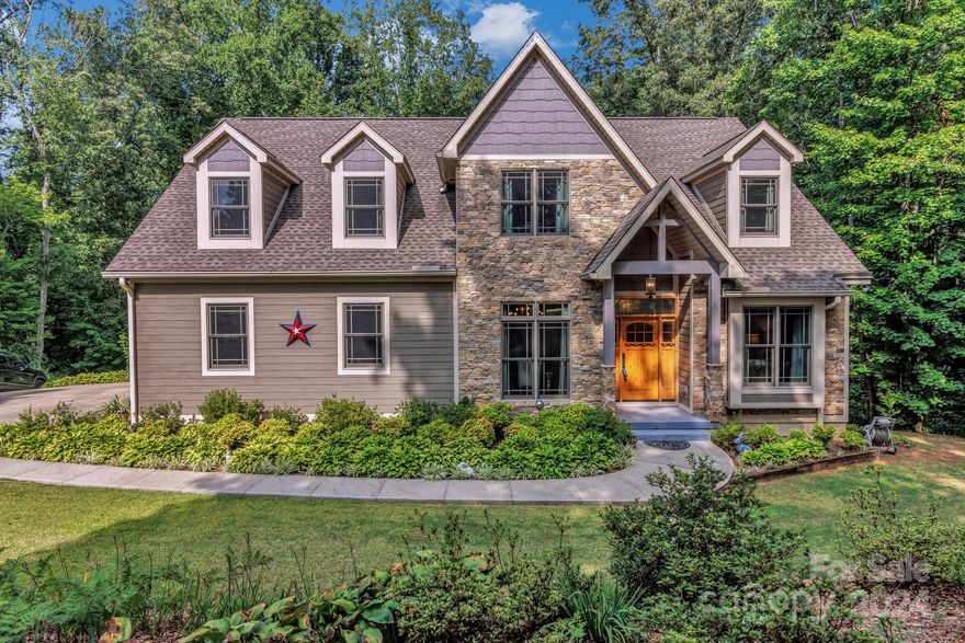 Welcome to your private oasis in the heart of Candler! This stunning, craftsman home boasts over 5.5 expansive acres of serene, wooded beauty, offering both tranquility and seclusion while still being conveniently close to local amenities. From the moment you arrive, you’ll be captivated by the impressive curb appeal of this modern masterpiece. The residence features a thoughtfully designed open floor plan with abundant natural light, creating a warm and inviting atmosphere. The gourmet kitchen is a chef’s dream, complete with stainless steel appliances, custom cabinetry, and a generous island perfect for meal preparation and casual dining. The adjacent living room, with its elegant fireplace and access to the deck, provides a perfect space for both relaxing and entertaining. The home offers a primary bedroom and office on the main floor. 2 bedrooms upstairs (one ensuite) with 2 bonus rooms. The basement offers a blank canvas for you to finish, plumbed for a kitchen and bathroom.
