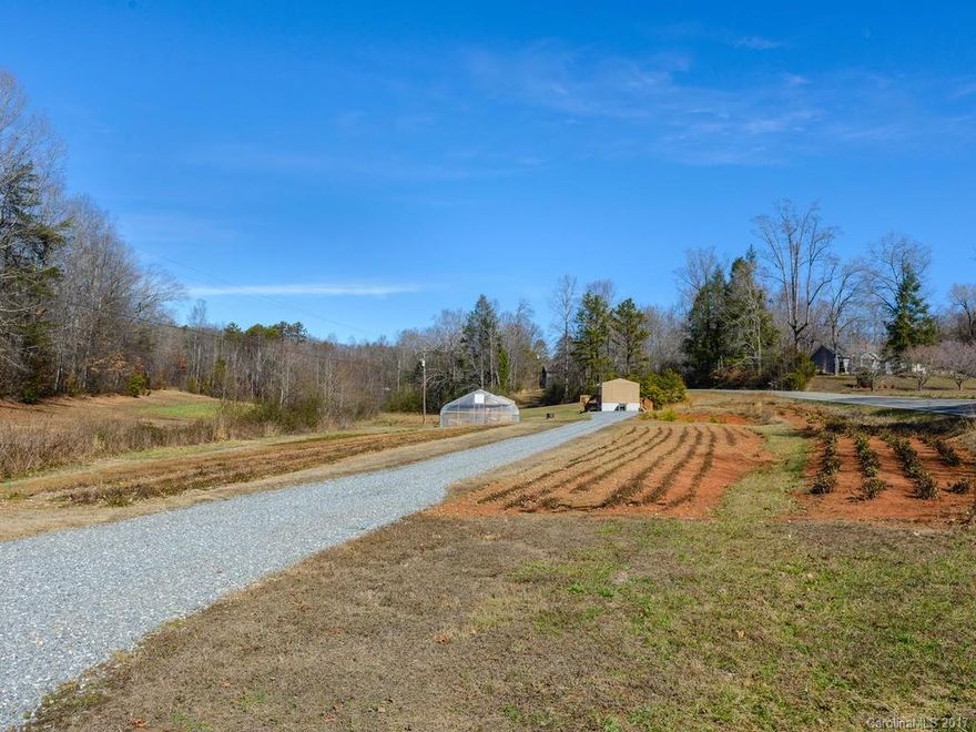 Are you looking to get out of the hustle and bustle? Be your own boss? Get out of the office and work outdoors? If so then the Fairview Herb Farm is the place for you. A successful functioning farm, currently used to grow valuable herb crops, this farm is your ticket to independence and self-sufficiency. Located within a half hour drive to Asheville, this beautiful farm has all you need to take complete control of your life.  Pasture, fields and the room to raise livestock along with your crops.