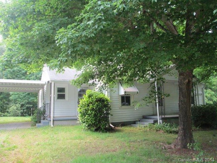 2 acres, house, detached garage, detached double carport all for under $60,000! Huge kitchen w/ lots of counter space. Laundry in breakfast area. Nice wood floors in LR, bedrooms. Walk in shower in bath. Insulated windows. Oil floor furnace, window AC. Partial walkout basement. Borders small branch at rear of property.