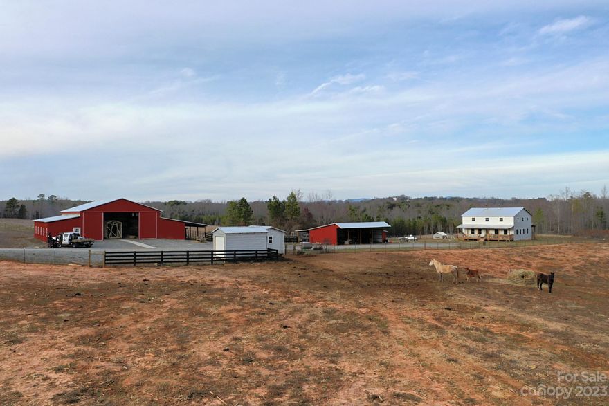 32+ acre farm within an hours reach of Charlotte, Hickory, Asheville or Greenville SC. 18 acres of cleared land with 14 acres of woods, trails and a creek to explore. Property has a large 2-story dwelling (2880 sqft) with open spaces and finished without electricity or conventional plumbing. It is well insulated with newer vinyl double-hung windows. There is a 4000 sqft enclosed metal shop/building on concrete with a 14'x60' lean-to as well as a 24'x40' shed with a 12'x40' lean-to behind it. There is also another 600sqft finished building that was used as a community school on the property. Most of the property is fenced in with welded wire/topped with barb wire and divided, with a farm-gated entrance.