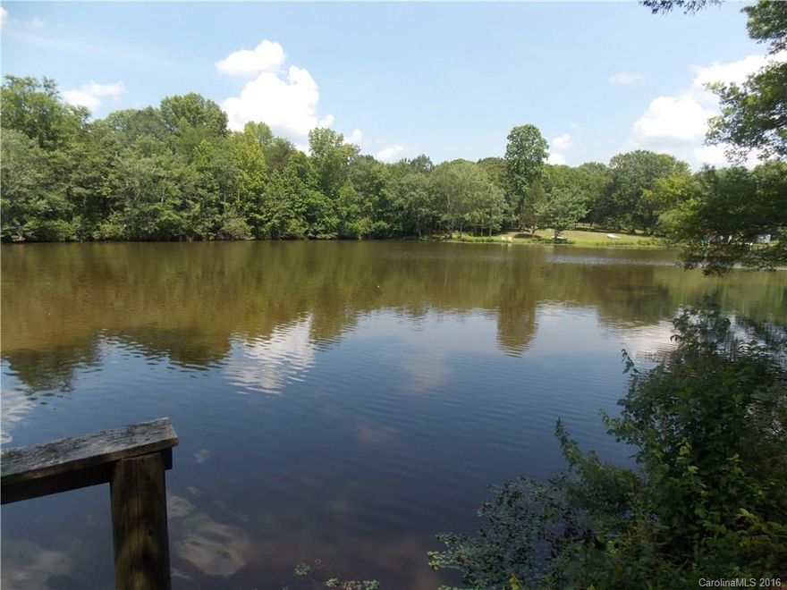 Waterfront property in a tranquil setting.  Sit on the deck that looks out over a large pond.  Ready for a buyer to construct a new home.  The 4.6 acre property has an existing well and septic system and an existing mobile home.  The property is being sold AS-IS.  The property also includes an unfinished garage that has a concrete floor.  A relatively flat lot located off of a paved cul-de- sac road.